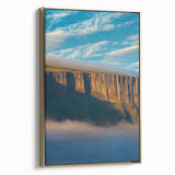 Framed canvas artwork showcasing a stunning landscape of dramatic cliffs, highlighted by golden hues and intricate details, ideal for home decor enhancement.