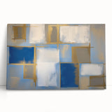 Abstract geometric canvas art piece showcasing vibrant blue, yellow, and red shapes, leaning against a textured white wall, perfect for modern home decor.
