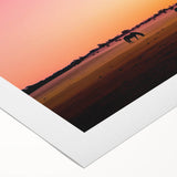 Vibrant rolled canvas showcasing a serene countryside landscape with rolling hills and a colorful sunset, elegantly packaged in a protective cardboard tube.