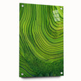 Vibrant acrylic glass landscape artwork depicting rolling green fields and a clear blue sky, showcased from a side view with decorative pins for secure mounting.