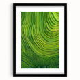 Framed landscape artwork in a black mat and frame, showcasing vibrant green fields under a clear blue sky, ideal for home decor and interior design.