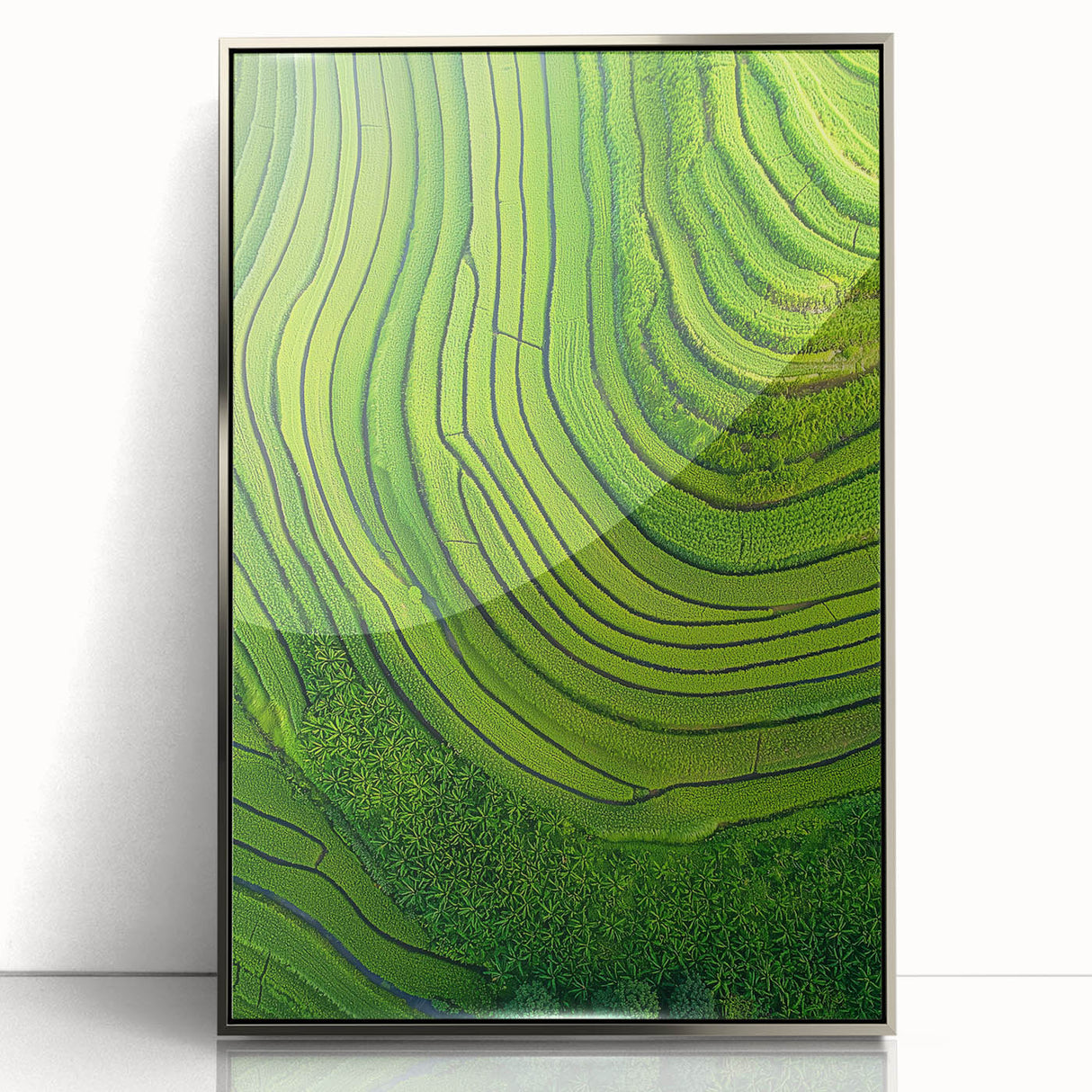 Framed acrylic artwork showcasing a serene landscape of lush green fields under a blue sky, highlighted by a silver frame, perfect for modern home decor.