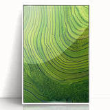 Framed acrylic artwork showcasing vibrant green landscapes with rolling fields, set in a sleek white frame, perfect for enhancing modern home decor.