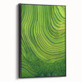Framed canvas artwork depicting serene landscapes and fields, featuring a black frame and side view, perfect for enhancing home decor with nature-inspired aesthetics.