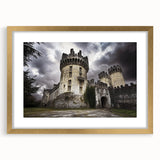 Framed landscape artwork depicting a majestic castle, featuring a gold mat and ornate frame, ideal for elegant home decor or gallery displays.