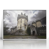 Framed acrylic artwork depicting a scenic landscape with castles, surrounded by lush greenery and blue skies, showcasing vibrant colors and intricate details.