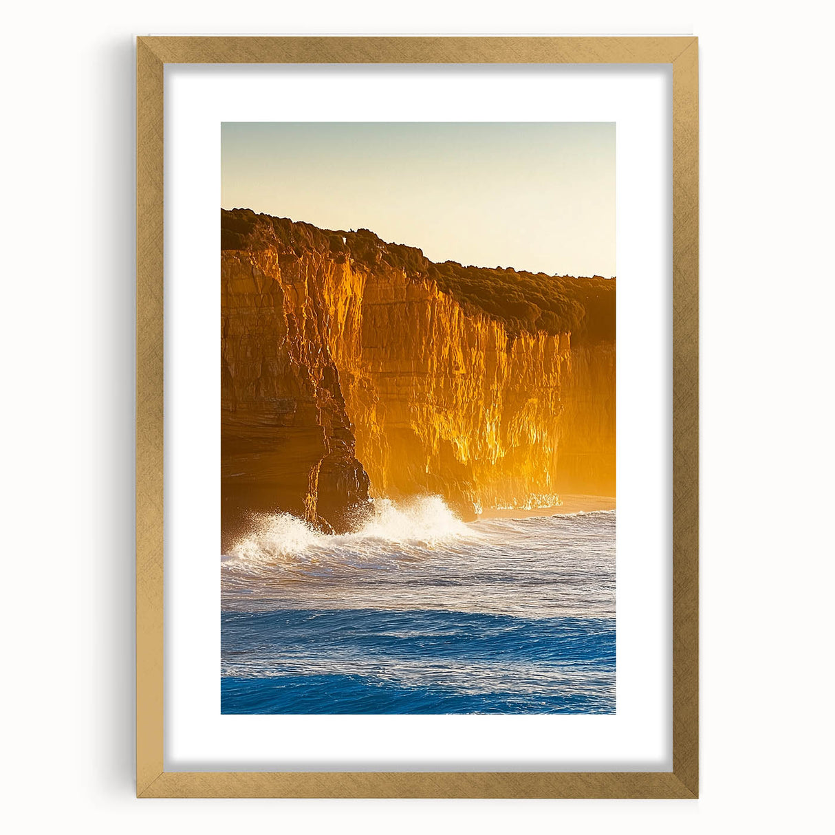 Elegant gold-framed landscape artwork showcasing dramatic cliffs under a clear blue sky, perfect for enhancing home decor with a touch of sophistication.