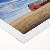 Rolled canvas artwork showcasing a vibrant landscape design featuring a rustic barn, presented in a protective cardboard tube. Ideal for home decor and art enthusiasts.