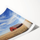 Rolled landscape barn print showcasing a rustic barn scene with vibrant colors, elegantly packaged in a protective cardboard tube for safe shipping.