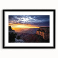 Framed landscape artwork showcasing stunning canyons in deep, rich colors, featuring a sleek black mat and stylish frame, perfect for enhancing home décor.