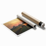 Rolled print showcasing a serene countryside landscape with vibrant green fields and a clear blue sky, packaged securely in a protective cardboard tube for easy transport.