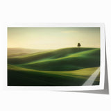 Vibrant landscape canvas print featuring rolling green fields under a bright blue sky, rolled tightly for shipping in a protective cardboard tube, ideal for home decor.