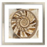 Textured art print of abstract nature elements in muted green and brown tones, framed in silver, ideal for bedroom decor.
