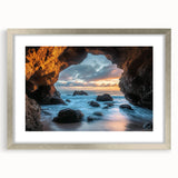 Silver-framed landscape artwork featuring intricate cave designs, presented with a mat. The piece showcases natural hues and textures, perfect for enhancing home decor.