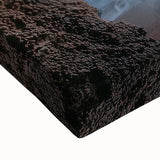 Close-up of a stretched canvas featuring a vibrant landscape design with intricate cave formations and rich earth tones, ideal for home decor.