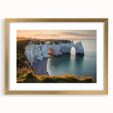 Elegant gold-framed landscape artwork showcasing dramatic cliffs and serene natural scenery, ideal for enhancing home decor with a touch of sophistication.