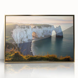 Framed acrylic artwork depicting dramatic cliffs against a vibrant sunset, showcasing rich gold tones and intricate details, ideal for modern home decor.