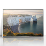 Framed acrylic landscape artwork showcasing dramatic cliffs and vibrant colors, set against a white frame, perfect for enhancing modern home decor.