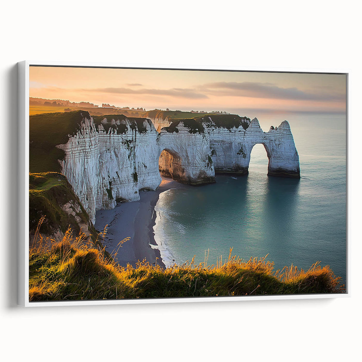 Framed canvas artwork showcasing a serene landscape of cliffs under a vibrant sunset, featuring subtle hues of orange and blue with a sleek white frame, perfect for modern decor.