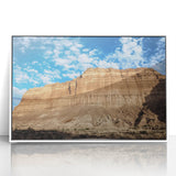 Framed acrylic landscape artwork depicting vibrant canyons in rich earthy tones, set in a sleek white frame, ideal for modern home decor and nature enthusiasts.