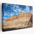 Stretched canvas artwork depicting a breathtaking landscape of canyons with rich earthy tones, showcasing dramatic rock formations under a vibrant sky, ideal for home decor.