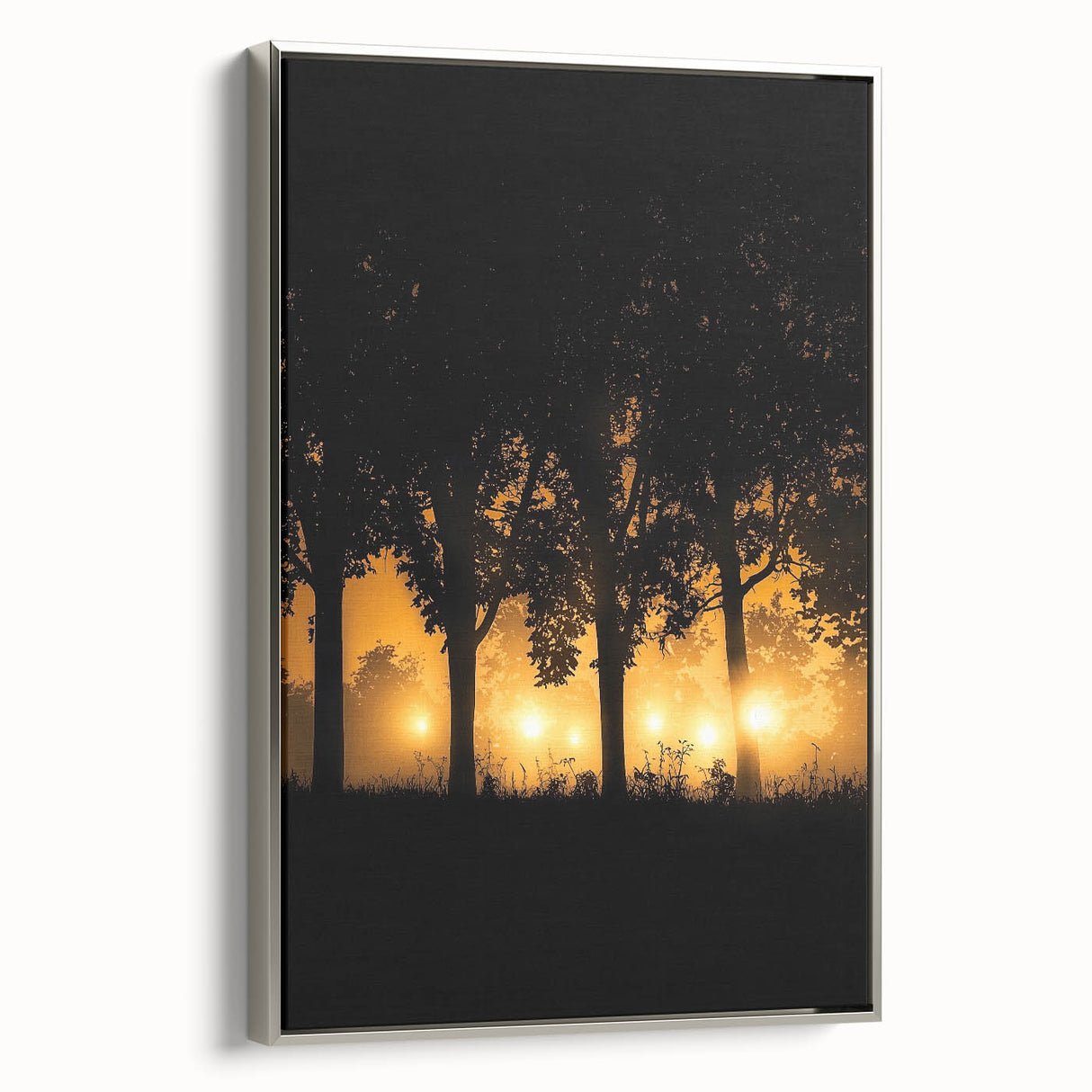 Framed canvas artwork depicting a serene countryside landscape with lush green fields and distant hills, featuring a sleek silver frame that enhances its elegance.