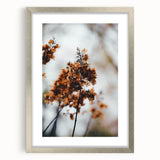 Textured abstract art print depicting fall colors in muted oranges and browns on a framed silver mat, ideal for bedroom art.