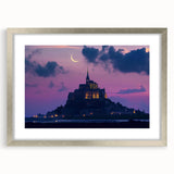 Framed landscape artwork showcasing a majestic castle surrounded by lush greenery, presented in a sleek silver frame with a mat. Ideal for home decor.