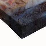 Close-up of a vibrant stretched canvas showcasing a detailed landscape design featuring intricate cave formations and earthy tones, ideal for home decor.