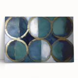 Abstract geometric stretched canvas artwork featuring vibrant blue and orange shapes, leaning against a neutral wall, perfect for modern home decor.