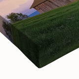 Close-up of a stretched canvas featuring a vibrant landscape barn design, showcasing rich colors and intricate details, ideal for rustic home decor.