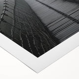 Rolled canvas artwork depicting a serene landscape bridge scene with vibrant colors and intricate details, ideal for home decor, packaged securely in a protective tube.