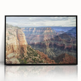 Framed acrylic artwork depicting a stunning landscape of canyons, featuring rich earth tones and dramatic rock formations, set against a sleek black frame. Perfect for nature lovers and home decor enthusiasts seeking a modern touch.