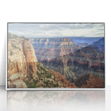 Framed acrylic landscape artwork showcasing vibrant canyons in rich earthy tones, set in a sleek white frame, perfect for modern home decor.