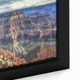 Close-up of a framed canvas artwork showcasing a vibrant landscape of majestic canyons in rich earth tones, perfect for enhancing home decor with natural beauty.