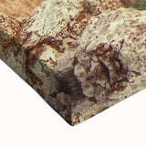 Close-up of a textured stretched canvas artwork depicting a vibrant landscape of canyons, showcasing warm earthy tones and intricate details, perfect for home decor.