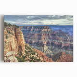 Stretched canvas artwork depicting a vibrant landscape of canyons in rich earth tones, showcasing dramatic rock formations under a clear blue sky, perfect for enhancing any living space or office decor.