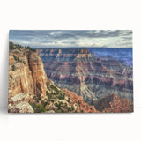 Stretched canvas artwork depicting a vibrant landscape of colorful canyons under a bright blue sky, perfect for enhancing home decor with natural beauty.