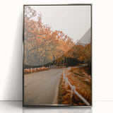 Mid-century modernist art depicting an abstract fall scene in warm orange and brown tones, framed in silver acrylic.