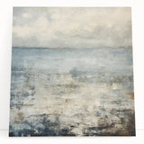 Abstract wall art featuring vibrant strokes in shades of blue, orange, and yellow, printed on stretched canvas and leaning against a neutral wall, perfect for modern decor.