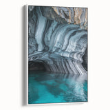 Framed canvas artwork depicting a serene landscape with cave formations, showcasing earthy tones and intricate details. The piece is presented in a sleek white frame, ideal for modern home decor.