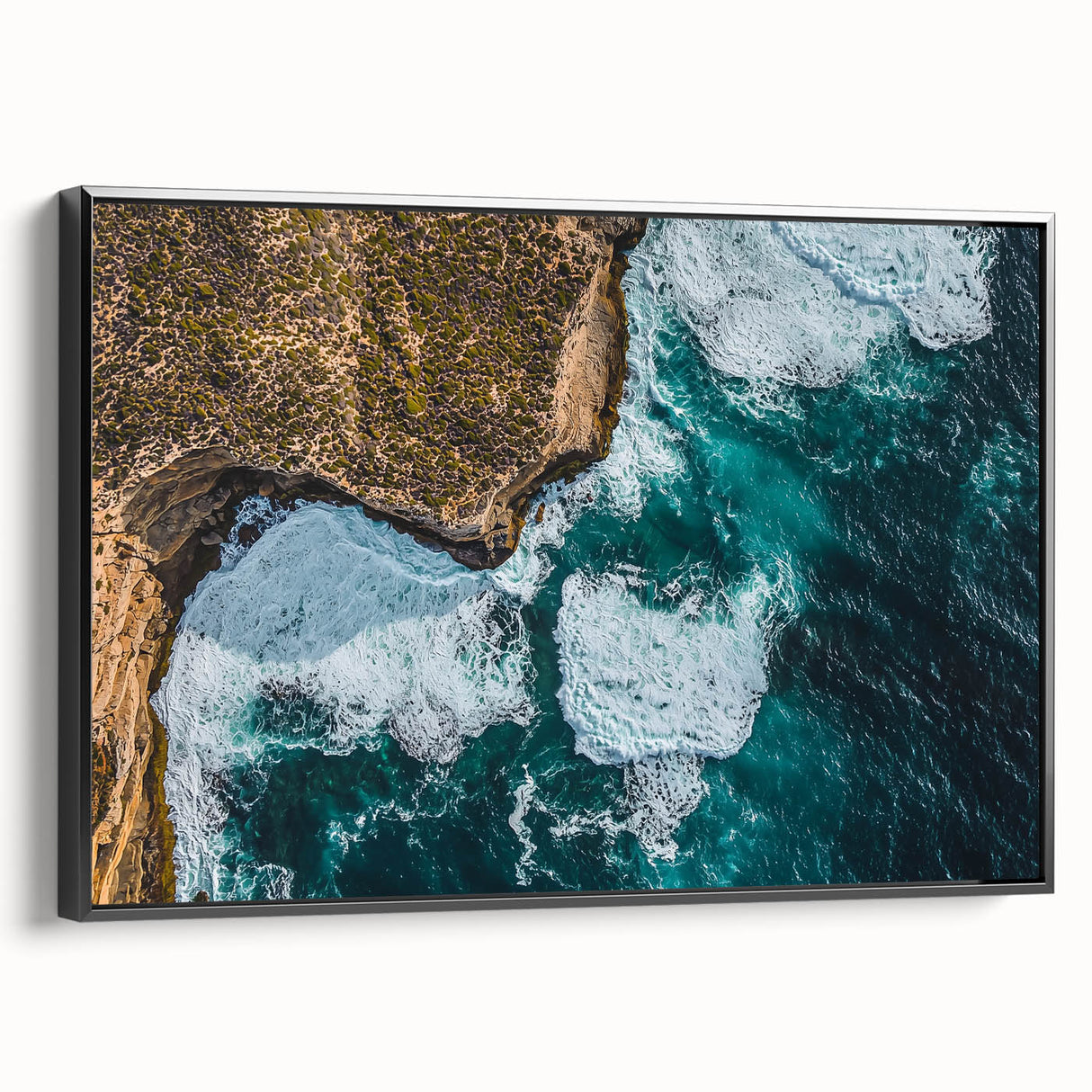 Framed canvas artwork depicting a breathtaking landscape of dramatic cliffs, showcasing vibrant colors and intricate details, with a sleek black frame enhancing its elegance.