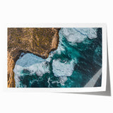 Vibrant landscape print showcasing dramatic cliffs and serene ocean waves, rolled for easy transport and display, perfect for enhancing home decor.
