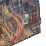 Close-up of a vibrant acrylic glass artwork depicting majestic canyons, showcasing rich earth tones and intricate textures, perfect for modern home decor.