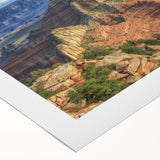 Stunning rolled canvas artwork depicting a vibrant landscape of canyons, showcasing rich earth tones and dramatic formations, ideal for home decor or office aesthetics.