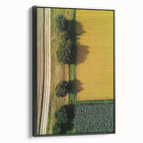 Framed canvas print of a serene countryside landscape, showcasing rolling hills and vibrant greenery, presented in an elegant black frame, ideal for home decor.