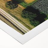 Rolled canvas artwork depicting a serene countryside landscape with rolling hills and vibrant greenery, elegantly packaged in a protective cardboard tube. Perfect for home decor enthusiasts seeking nature-inspired art.
