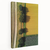 Stretched canvas artwork depicting a serene countryside landscape with rolling hills, vibrant greenery, and a clear blue sky, ideal for home decor.