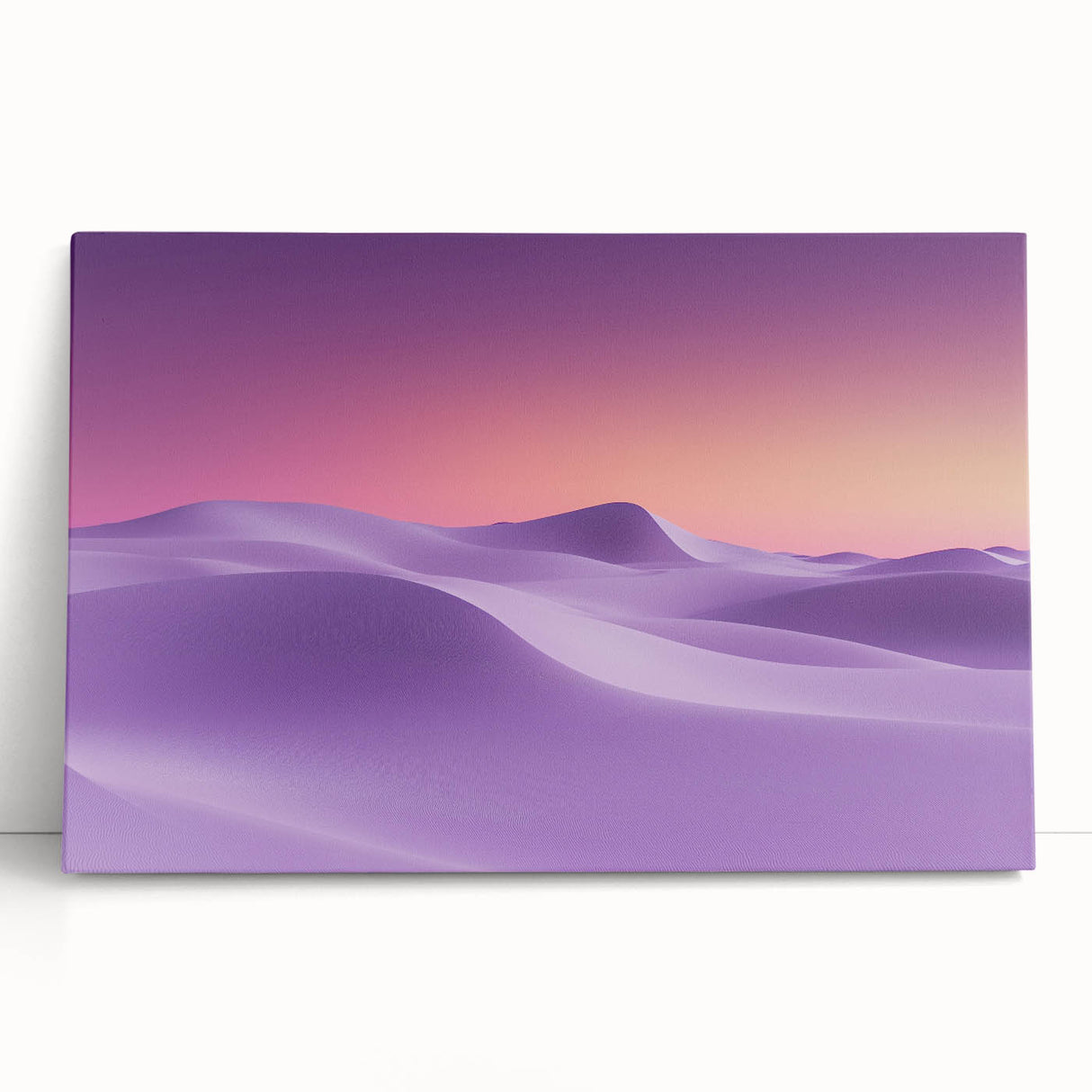 Desert landscape canvas artwork featuring a vibrant sunset with warm oranges and deep blues, elegantly leaning against a neutral wall, enhancing modern decor.
