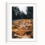 Abstract art print depicting fall season in orange and yellow tones on a white framed canvas, suitable for dining room decor.